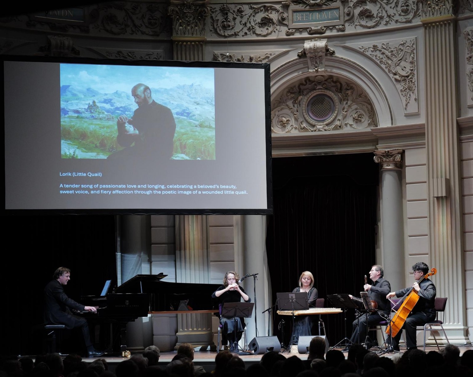 Zartonk Consort at Het Concertgebouw, with a projected image introducing Lorik.
